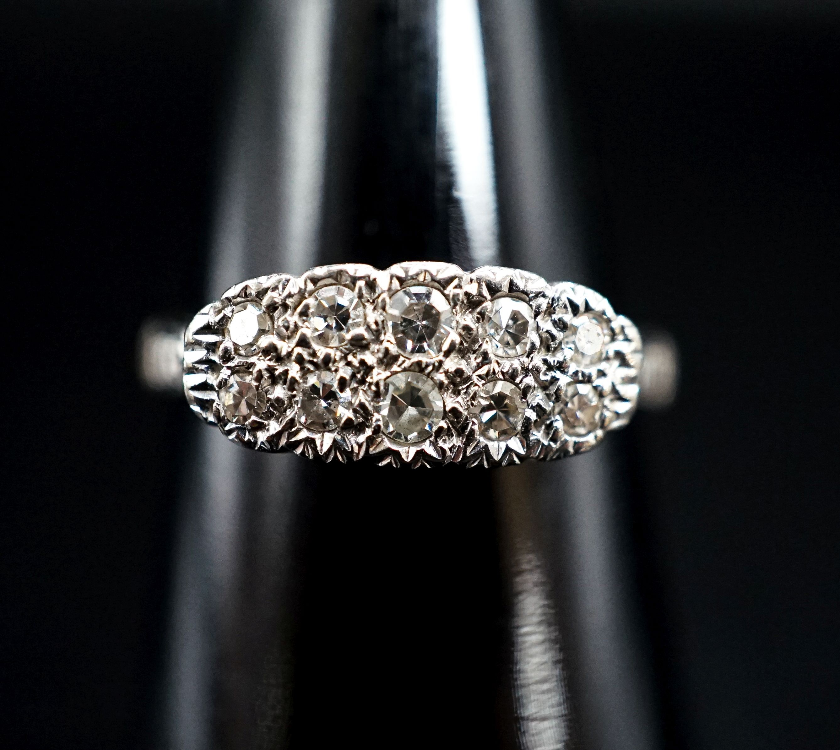 An 18ct & plat and two row diamond set cluster ring, size O, gross weight 2.7 grams.